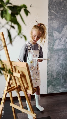 Cozy indoor environment with art supplies and a child artist painting. Scene highlights importance of creative atmosphere and artistic exploration for children.