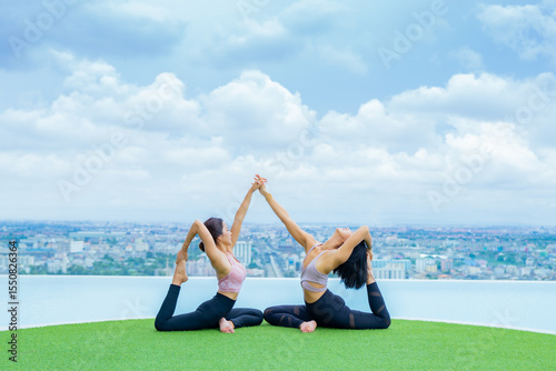 yoga, Asian woman wearing yoga clothes practicing yoga, Asia group of women exercising healthy lifestyle in outdoor fitness studio. swimming pool. Sport activity, gymnastics or ballet dancing class.