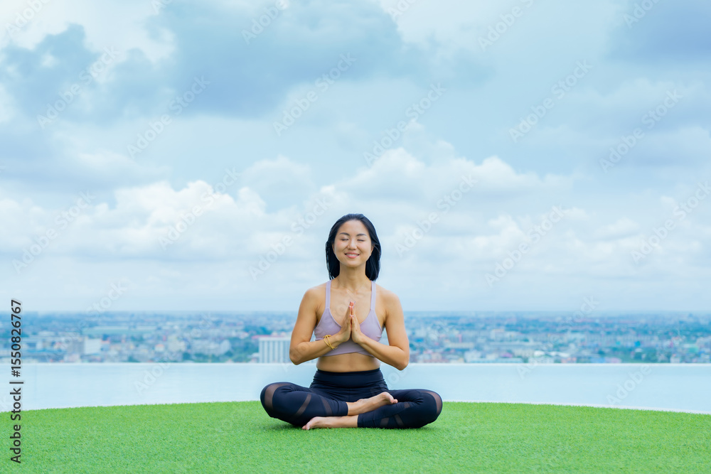 Fototapeta premium yoga, Asian woman wearing yoga clothes practicing yoga, Asia group of women exercising healthy lifestyle in outdoor fitness studio. swimming pool. Sport activity, gymnastics or ballet dancing class.