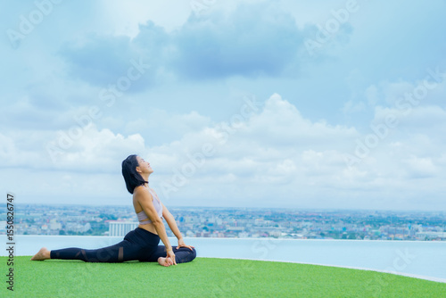 yoga, Asian woman wearing yoga clothes practicing yoga, Asia group of women exercising healthy lifestyle in outdoor fitness studio. swimming pool. Sport activity, gymnastics or ballet dancing class.