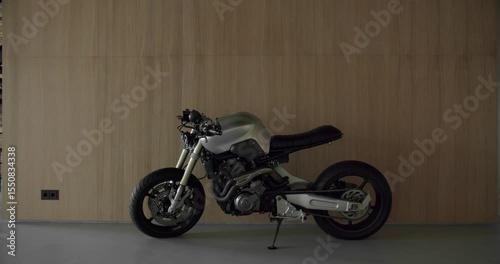 Minimalist wooden wall with concrete floor. Luxury living room design. Sports motorcycle inside the Minimalist Modern House as a parking space.