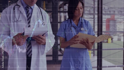 Physician and nurse shifting documents while consulting records and displaying health chart overlay