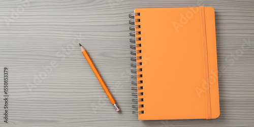 Orange Notebook and Pencil on a Grey Wood Desk