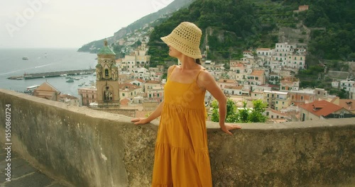 Wallpaper Mural Woman poses on terrace overlooking Amalfi harbor with colorful town behind her Torontodigital.ca