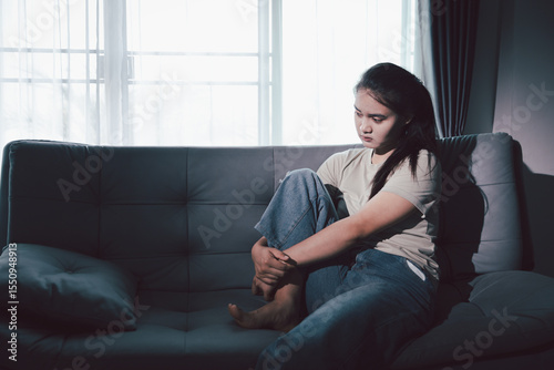Depression woman sit on sofa. Despair sorrow person sitting alone and hugging knees, Boring sad upset frustrated stressed. struggling to find hope amid suffocating burden. mental health concept.