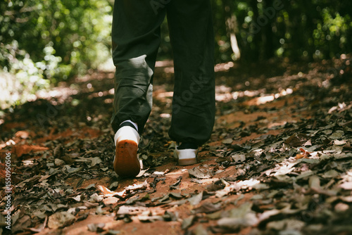 Hiking action on mountain grass trail path. Close up of female hiker shoe. adventurous lifestyle of hiker and backpack to travel and trek mountain, enjoy every walk and hike part of thrilling journey