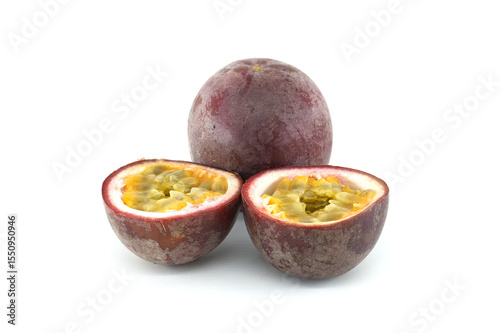 Fresh passion fruits, Passiflora edulis, presenting a whole fruit and two halves showing the pulp and seeds