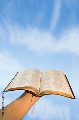 Low angle view of hand holding open Bible