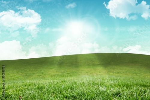 Rolling grassy hill is appearing in flat design meadow, with sun rays and white clouds