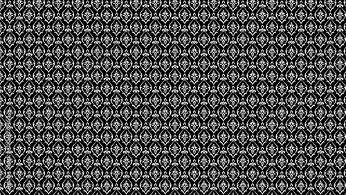 Black background with a symmetrical white floral pattern repeated across the entire image surface area