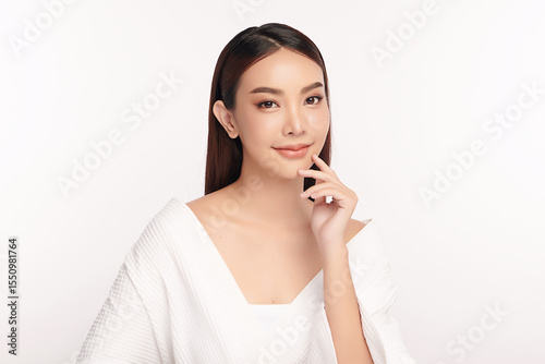 A beautiful young Asian woman with clean, fresh skin against a white background. Skincare, facial treatment, cosmetology, beauty, and spa. An elegant portrait of an Asian woman.