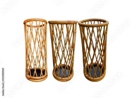 The white background in the picture is a tall wicker basket with a hollowed-out pattern and design. It has a strong base and a solid top edge. It is a basket that holds an umbrella for convenience.