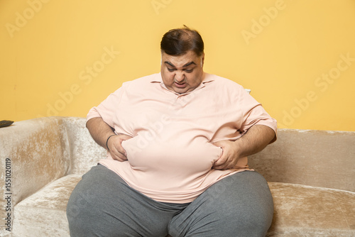 Quadro su tela Obesity - Unhappy overweight indian man have problem with big belly fat