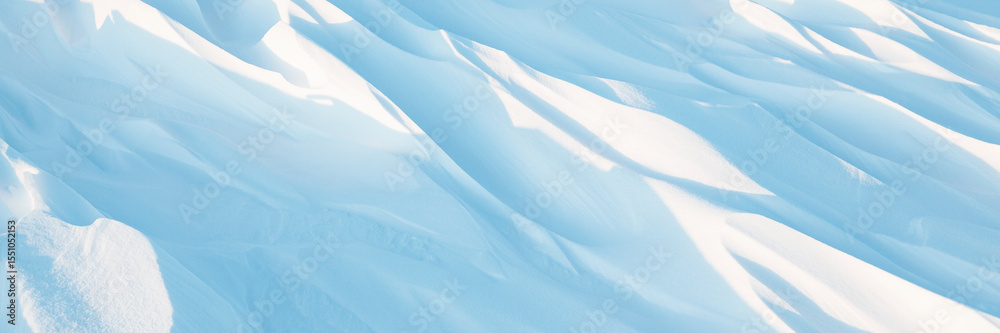 Fototapeta premium Snow texture. Wind sculpted patterns on snow surface. Wind in the tundra and in the mountains on the surface of the snow sculpts patterns and ridges (sastrugi). Arctic, Polar region. Winter background