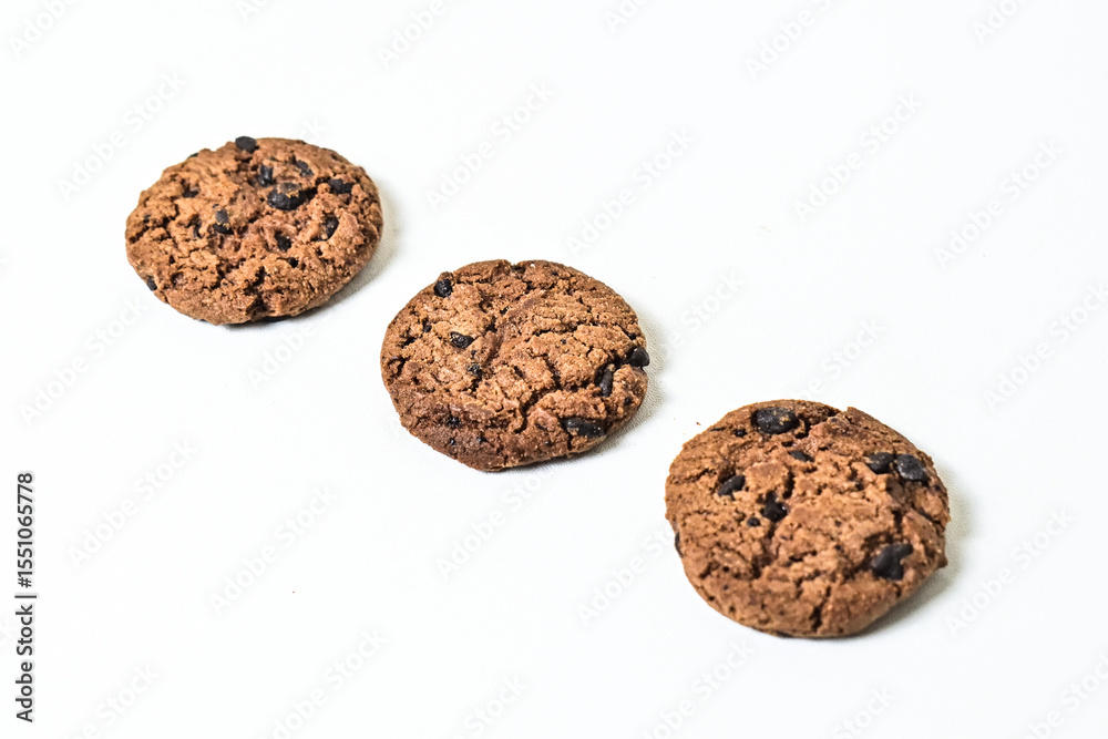 Fototapeta premium Close up view of three chocolate chip cookies isolated on white background. clipping path.