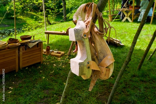 Handcrafted Wooden Shoes and Medieval Accessories on Display. Authentic Wooden Footwear at Historical Reenactment Fair. Selective focus.