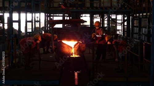 Rajkot, Gujarat, India 03 26 2025: workers are filling molten metal in casting components with casting furnace 
