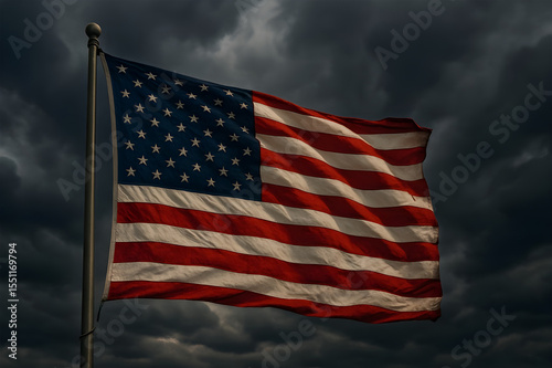 Stormy sky with American flag flying strongly in the wind.