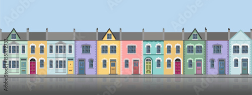 Long row of colorful city house facades with water reflection, brittish style. 