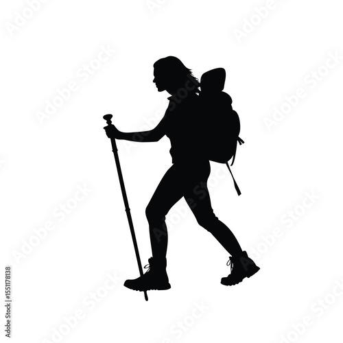 Silhouette of a woman hiking with a backpack and trekking pole.