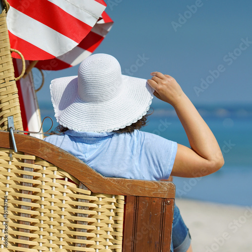 young and happy Woman in White Sun Hat Relaxing at the Beach