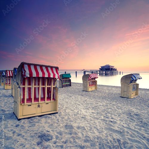 Sunset Bliss at Timmendorfer Strand: Vibrant Beach Chairs and the Pier Silhouette