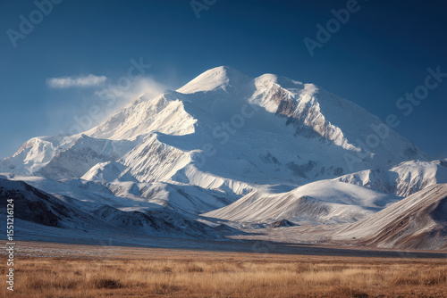 breathtaking view of lenin peak under clear sky illuminated by soft morning light