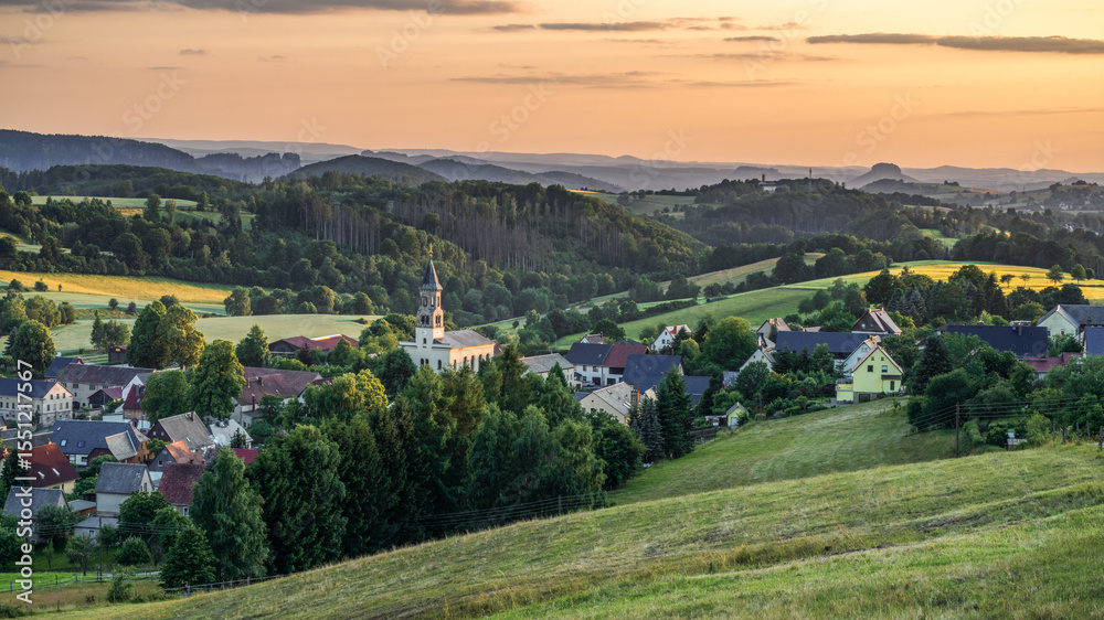 Naklejka premium a village in the evening light - Ein Dorf im Abendlicht