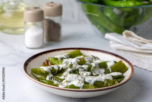 From Turkish cuisine, served with yogurt sauce on fried green peppers. Turkish name; Yogurt soslu biber kizartmasi