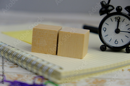 wooden blocks scattered on the wooden table with wooden figures as a people concept. 