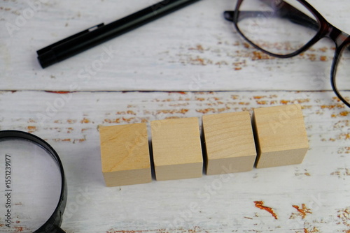 wooden blocks scattered on the wooden table with wooden figures as a people concept. 