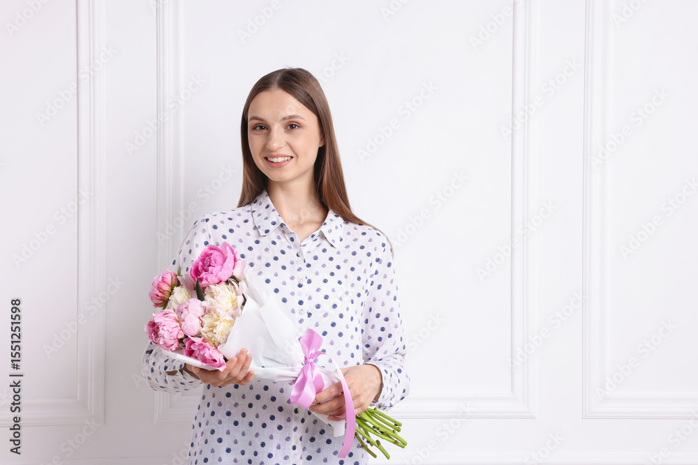 Woman with beautiful bouquet of peonies near white wall indoors, space for text Woman with beautiful bouquet of peonies near white wall indoors, space for text