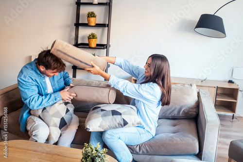 Young couple sitting on the sofa making peace after an argument. Reconnecting emotionally, sharing an intimate and honest moment of forgiveness, reconciliation and renewed love in a real-life relation