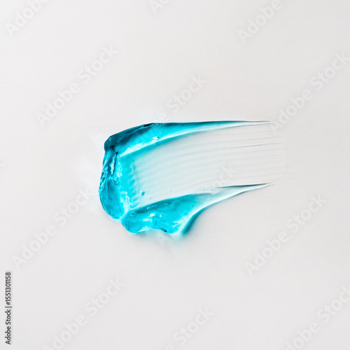 A smear of blue cosmetic hair gel on a white background