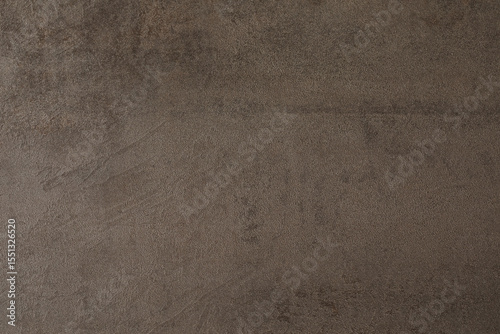 Art background of brown roughly plastered wall, copy space.