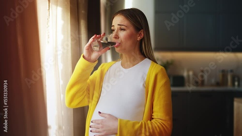 Sad pregnant woman taking supplement with water, feeling unwell, seeking relief