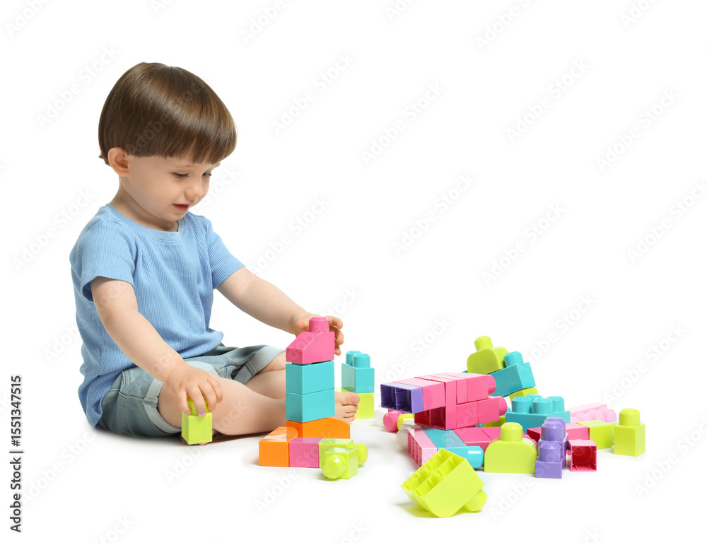 Obraz premium Cute little boy playing with building bricks on white background