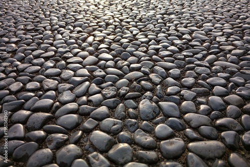 Fototapeta Naklejka Na Ścianę i Meble -  real rock, stone, pebbles floor ground, seamless pattern with golden sunrise, sunset reflection light. Outdoor street design element. Full screen picture, textured wallpaper background with copy space