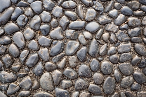 Fototapeta Naklejka Na Ścianę i Meble -  real rock, stone, pebbles floor ground, seamless pattern with golden sunrise, sunset reflection light. Outdoor street design element. Full screen picture, textured wallpaper background with copy space