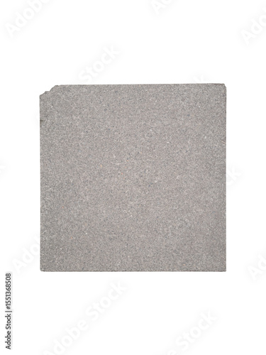 Square gray concrete tile with chipped corner is isolated.
