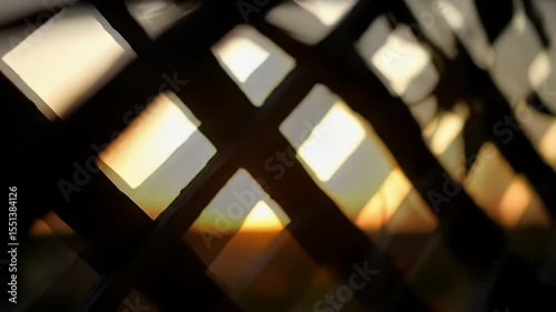 Abstract sunset light through wooden lattice