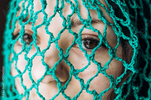 Portrait of young woman with mesh bag on head, eco lifestyle and sustainability.