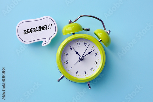 A green alarm clock and a reminder message next to it: Deadline!