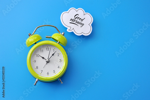 A green alarm clock and the message 