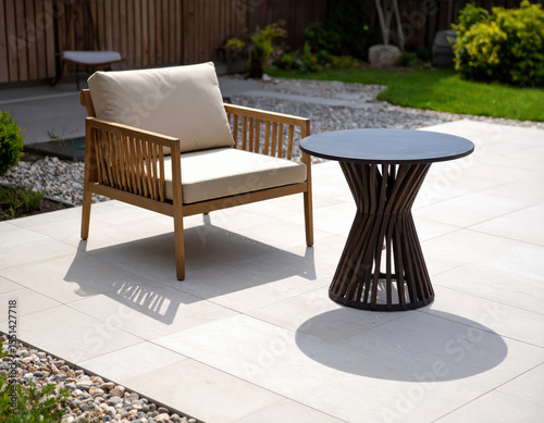 Beige Outdoor Chair and Dark Table on Textured Stone Patio