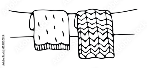 Hand drawn black and white illustration of two decorative towels with different unique fabric designs hanging from a line.