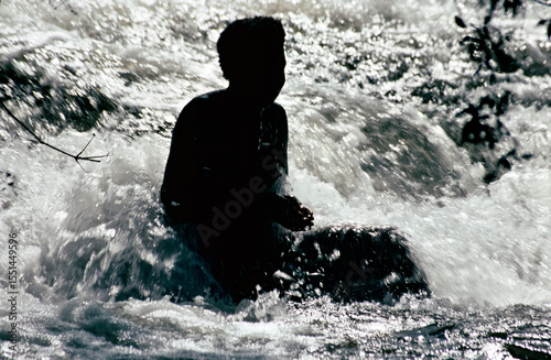silhouette of a woman in a waterfall
