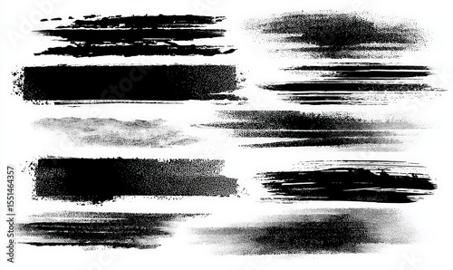 A collection of grunge black brush strokes and splatters on a white background, showcasing various textures and patterns.