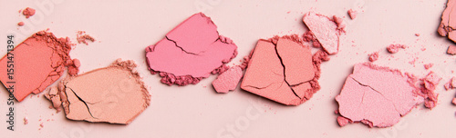 Eyeshadow and blush cosmetics textures spread on surface, background