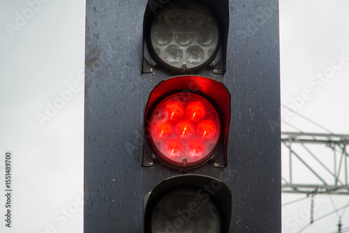 Red light at railway traffic lights. Prohibition of movement. Stop. Concept of constraints.